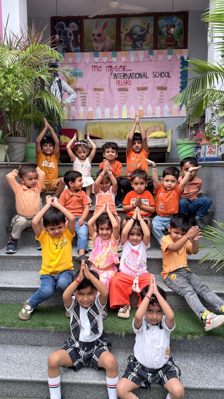 Children doing yoga poses on the school steps